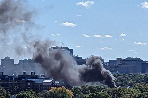 Smoke rises above Cambridge and the Charles