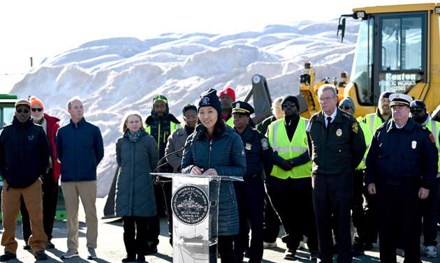 City officials brace for winter in front of a giant salt pile