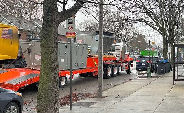 Flat bed with HVAC equipment at a bus stop