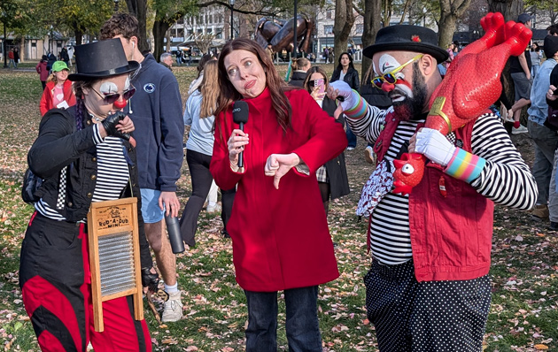 Clowns and reporter giving thumbs down on something